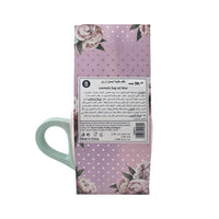 Mint green handled mug in purple floral gift box with care label panel