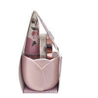 Tulip-shaped pink mug with body care bottles in floral gift box