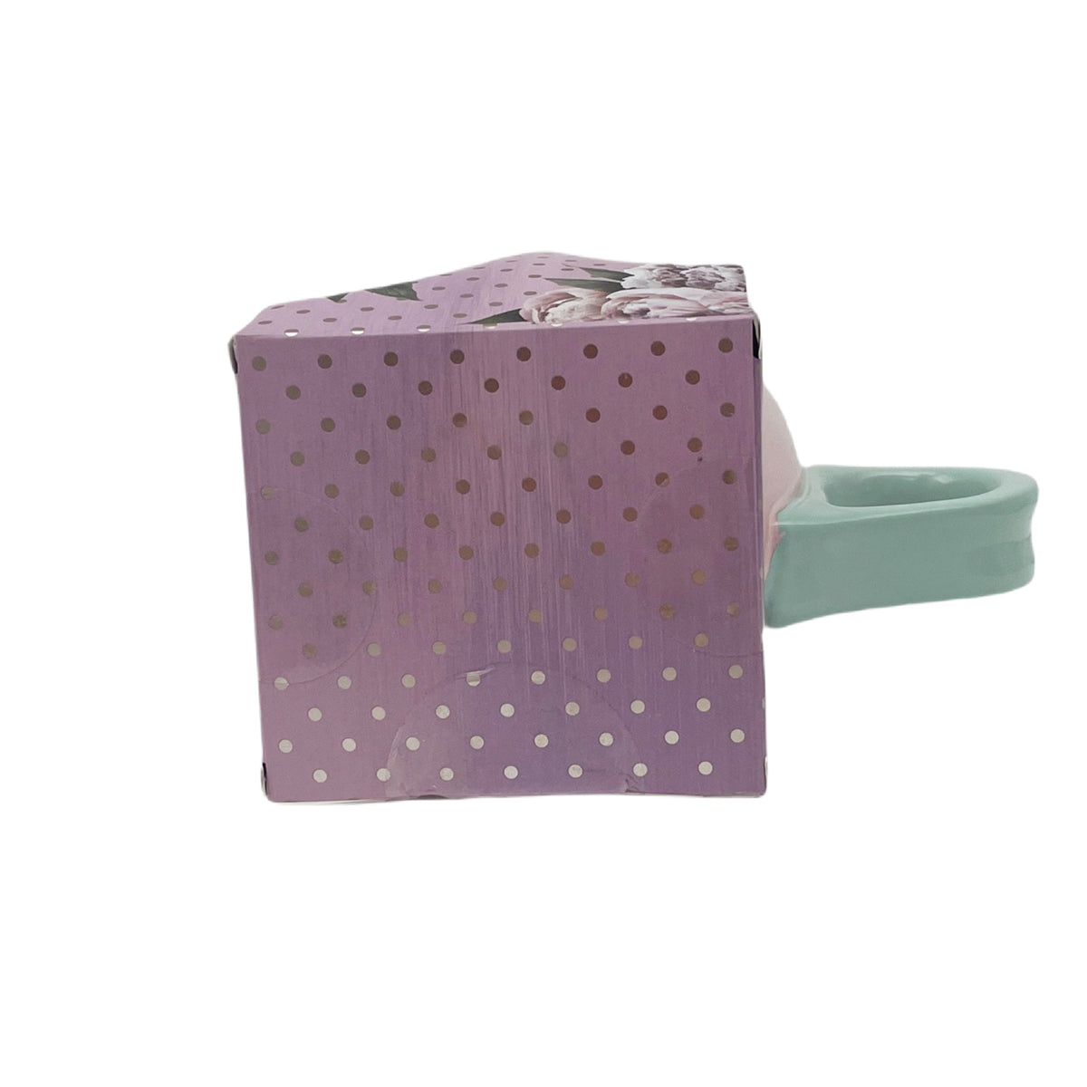 Gift bag with pink mug and mint handle, purple dotted floral packaging.