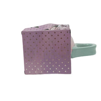Gift bag with pink mug and mint handle, purple dotted floral packaging.