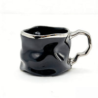 Ceramic cup with modern metallic handle design 1