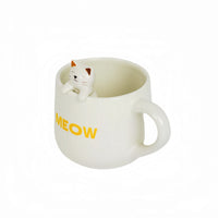 White ceramic mug with cat topper and yellow 'MEOW' on side.