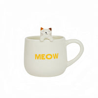 White ceramic mug with cat topper and yellow 'MEOW' print.