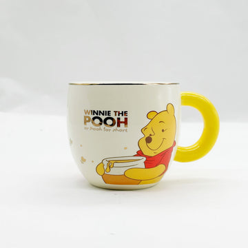 Cream Winnie the Pooh cup with yellow handle and Pooh character illustration