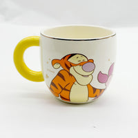Cream Winnie the Pooh Qiyuan cup with yellow handle and Tigger-style character graphic