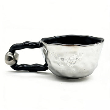 Ceramic cup with butterfly design and irregular rim 1
