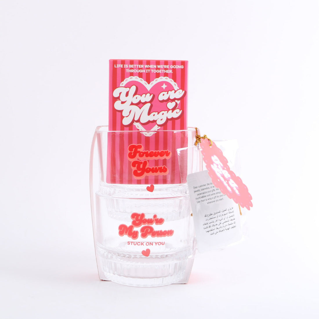 Two-glass set with red card wrap and ribbon, hearts and printed text.