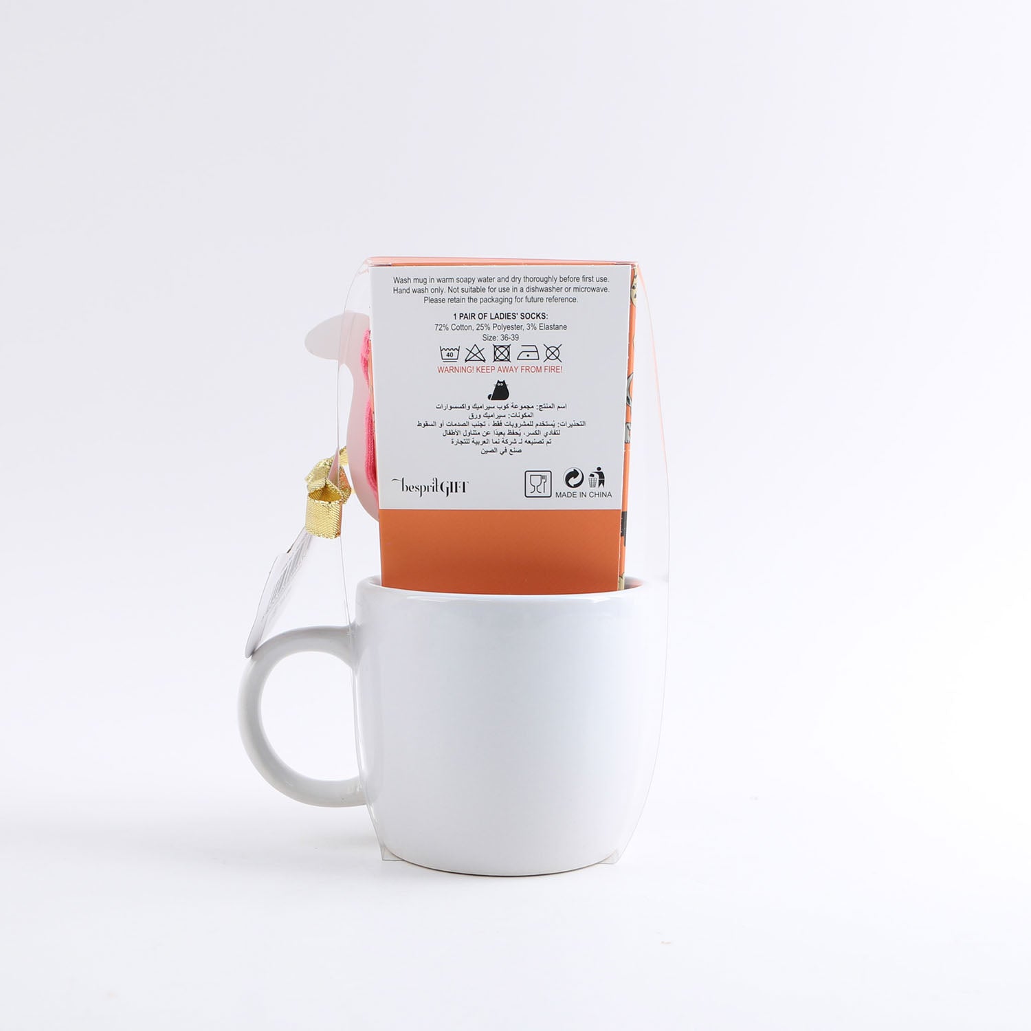 White ceramic mug with back packaging label, cat gift box sleeve and gold ribbon