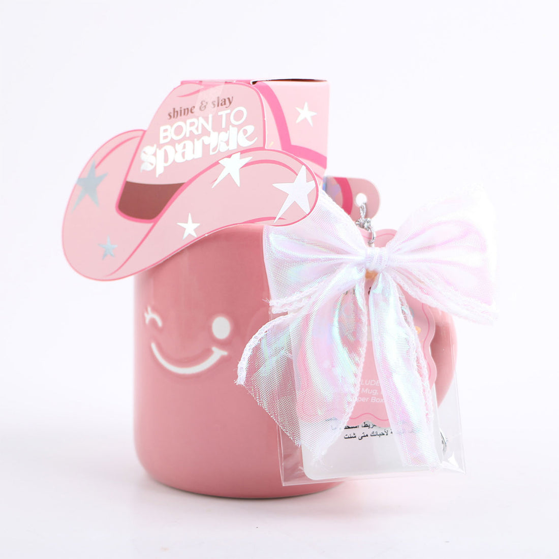 Pink ceramic mug with unicorn-hat lid and white ribbon bow, in paper box