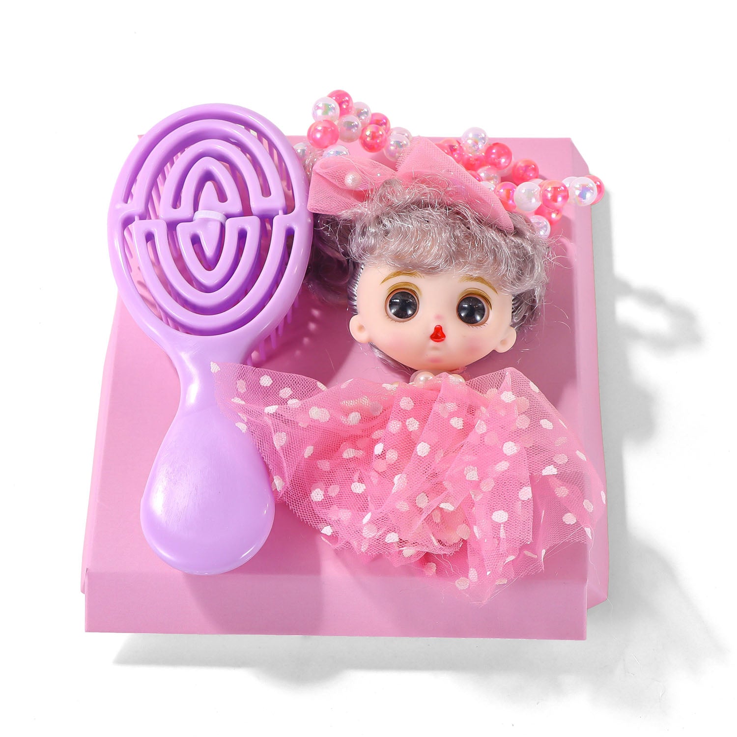 Doll figure with pink outfit holding a purple maze-shaped accessory