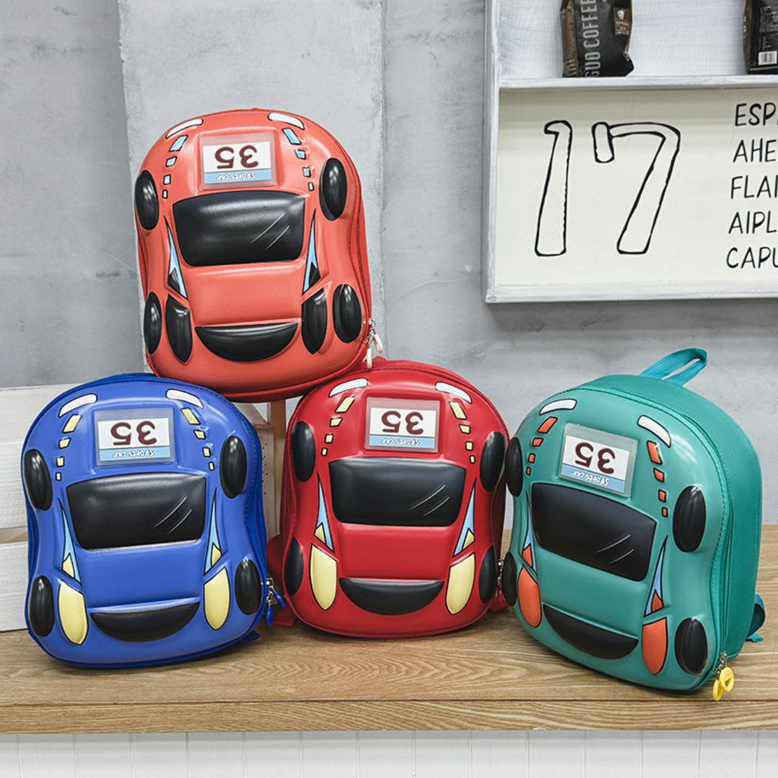 Set of car-shaped light-up children’s backpacks in red, blue, turquoise, and orange.