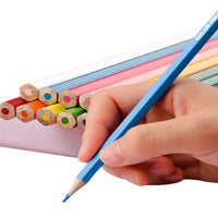 Hand holding a blue color pencil while drawing, with other pencils nearby