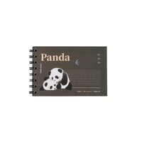 Small spiral notebook with dark brown panda cover, grid panel, and bird icon