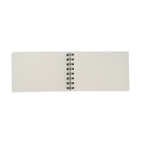 Small spiral notebook open view with blank pages and black spiral binding