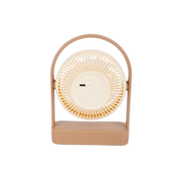 Compact desktop fan with round front grille and light tan base, centered controls