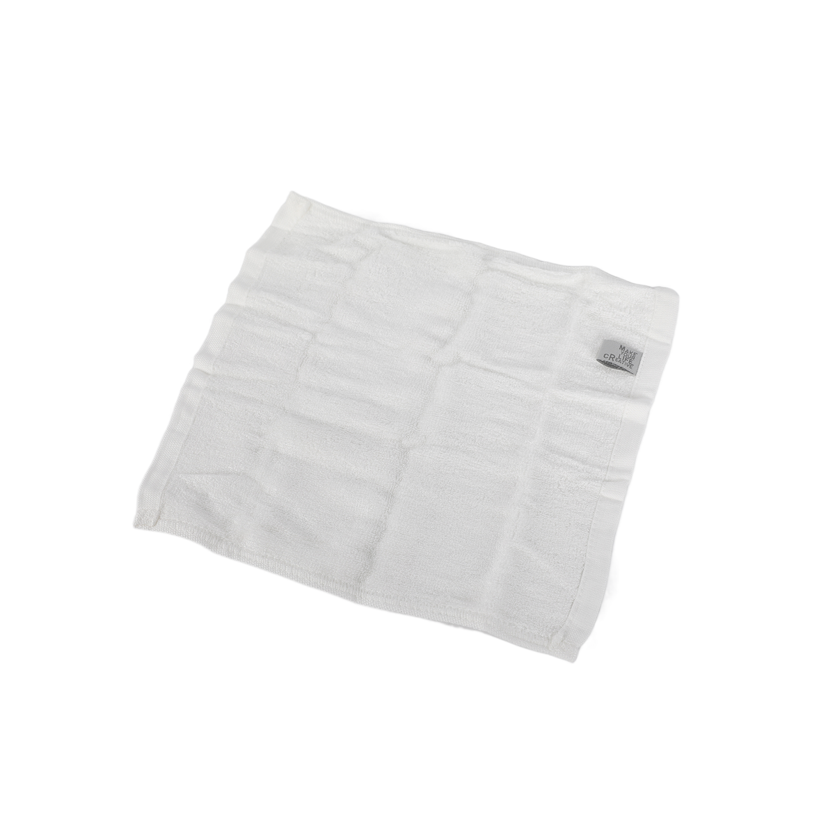 White facial cleansing cloth, folded with visible stitching and texture