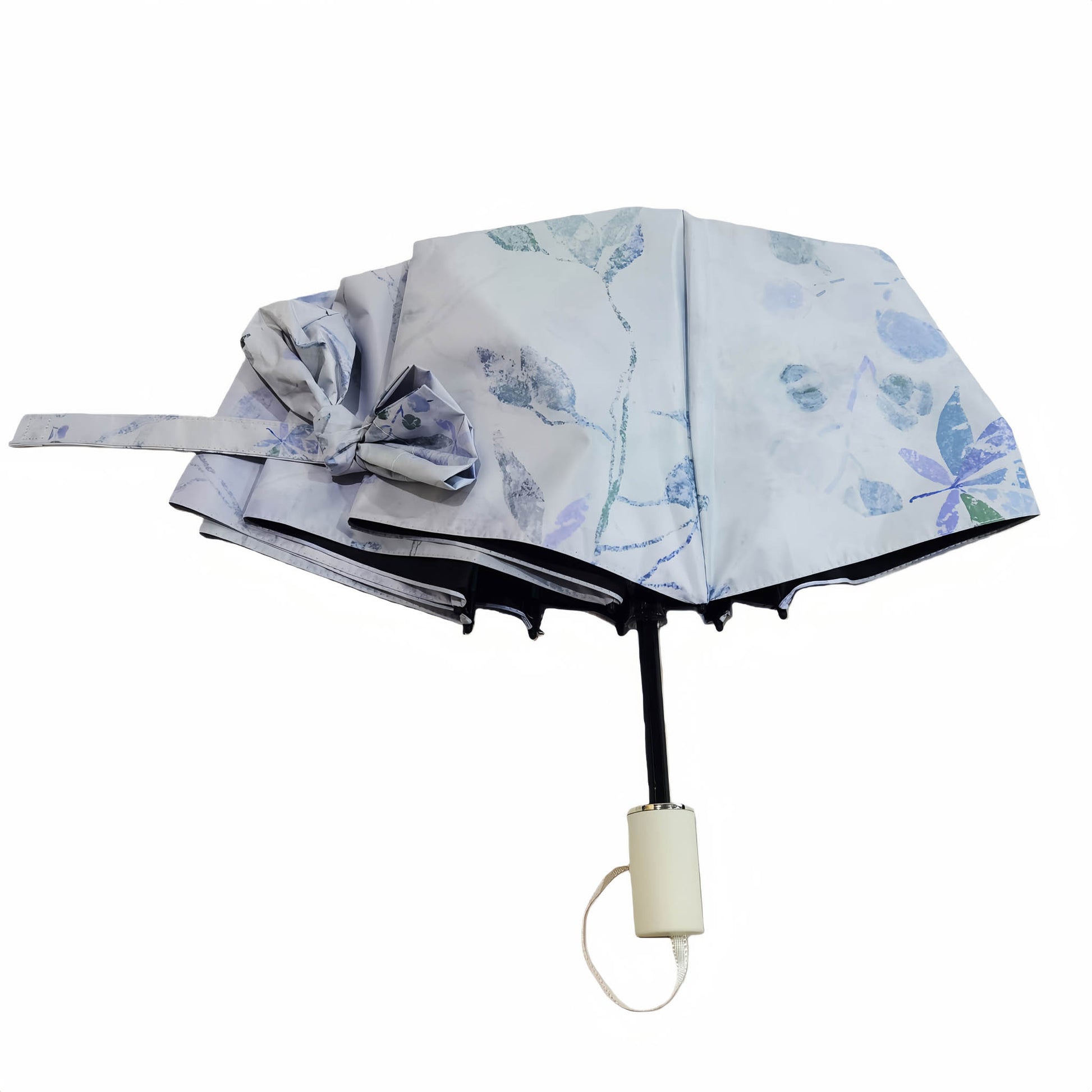 Blue floral folding umbrella, open canopy with black pole and beige handle cap