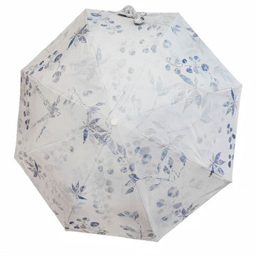Folding umbrella with white fabric and blue floral pattern, round button center