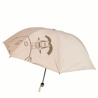 Folding umbrella, beige canopy with robot graphic and black pole