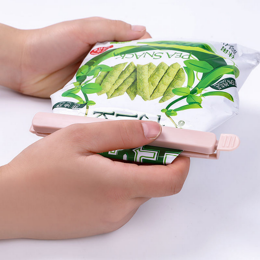 Pastel sealing clips with pink handles, used to close snack bags