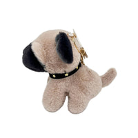 Plush dog keychain with tan fur, navy ear patch, star collar, and gold clip