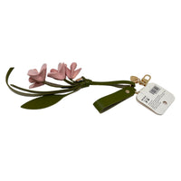 Green keychain with pink flowers and dangling leaf ends, gold keyring and tag.
