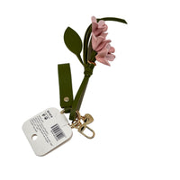 Green keychain with pink flower sprigs, gold lobster clip, and barcode tag.