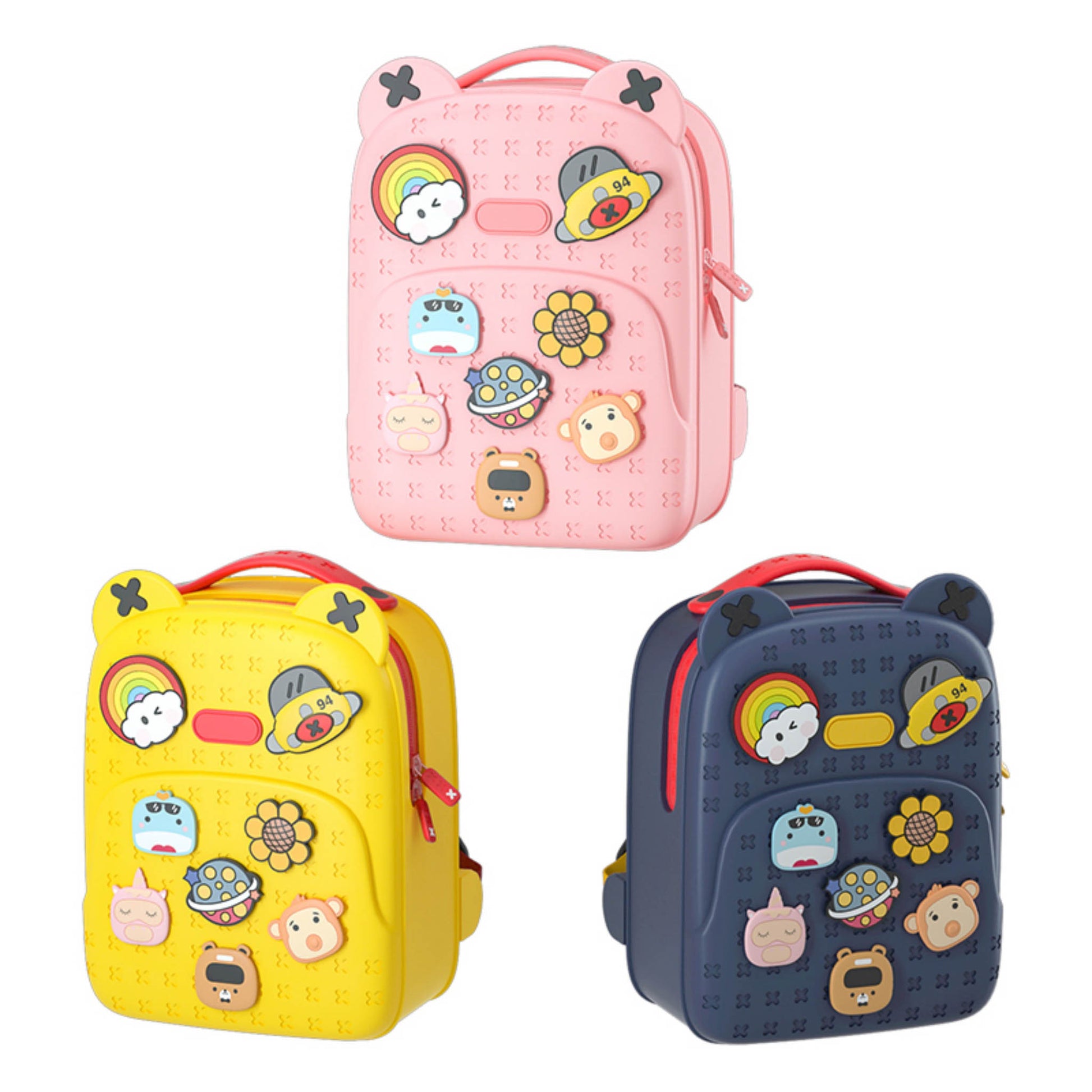 Three silicone backpacks: pink, yellow, and dark blue with cartoon animal patch details