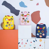 Set of three silicone backpacks in yellow, pink, and navy with cartoon patches