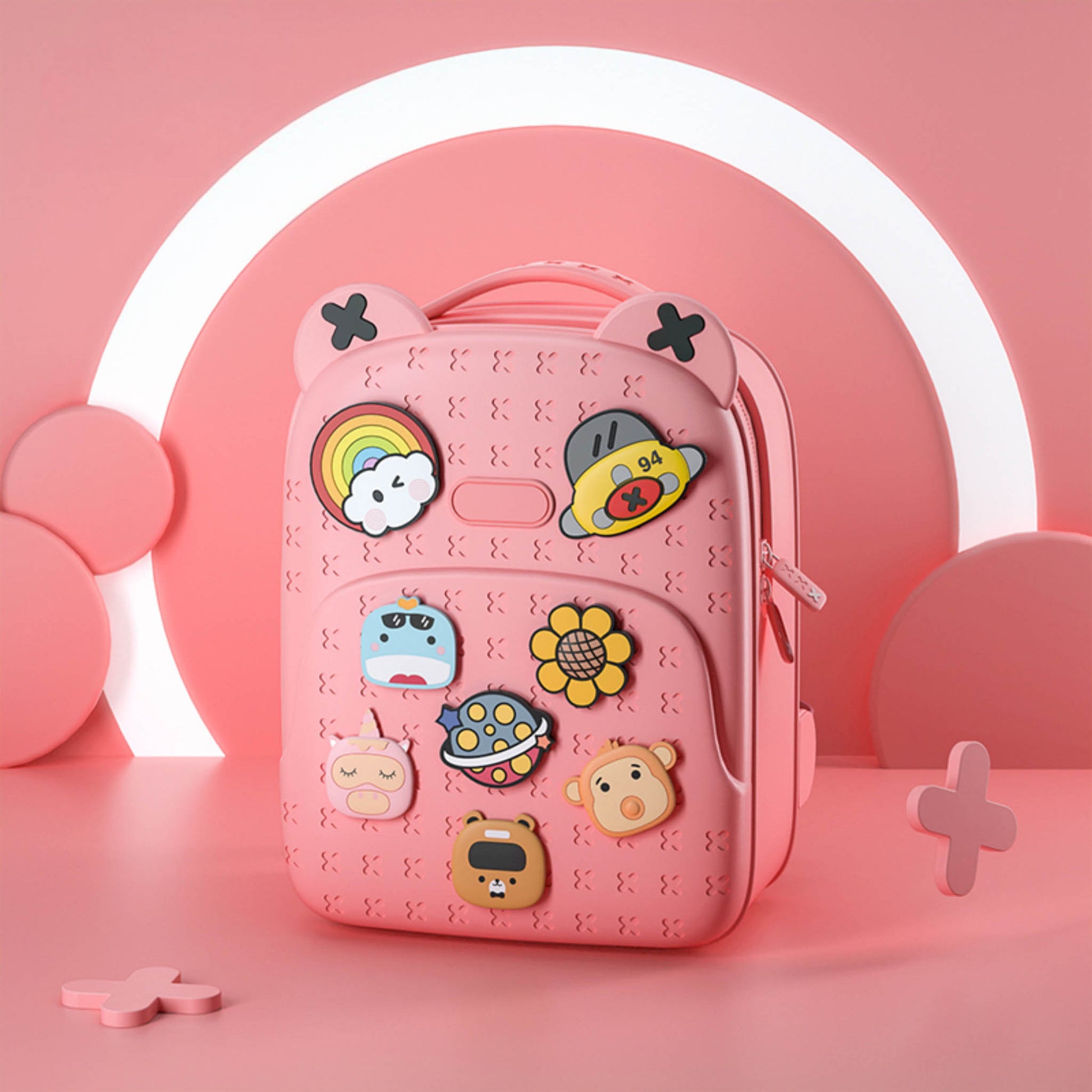 Pink silicone backpack with red zipper, cartoon animal badges and front pocket