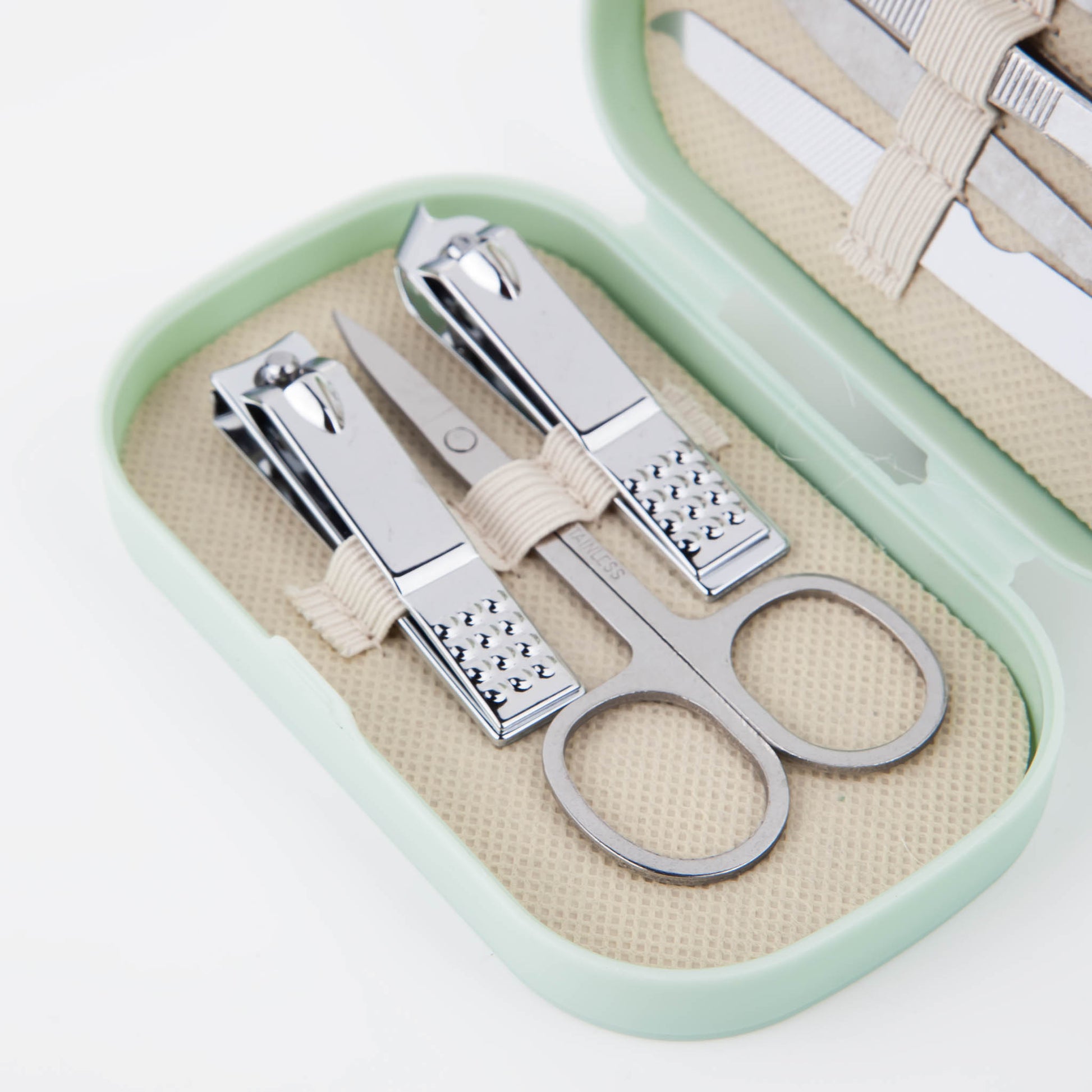 Manicure tool set in mint case with scissors, nail file, and ring-shaped metal tools