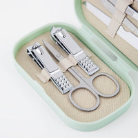 Manicure tool set in mint case with scissors, nail file, and ring-shaped metal tools