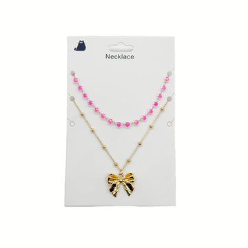 Gold necklace with pink bead accents and bow charm pendant