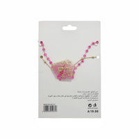 Gold necklace with pink bead strand and bow pendant