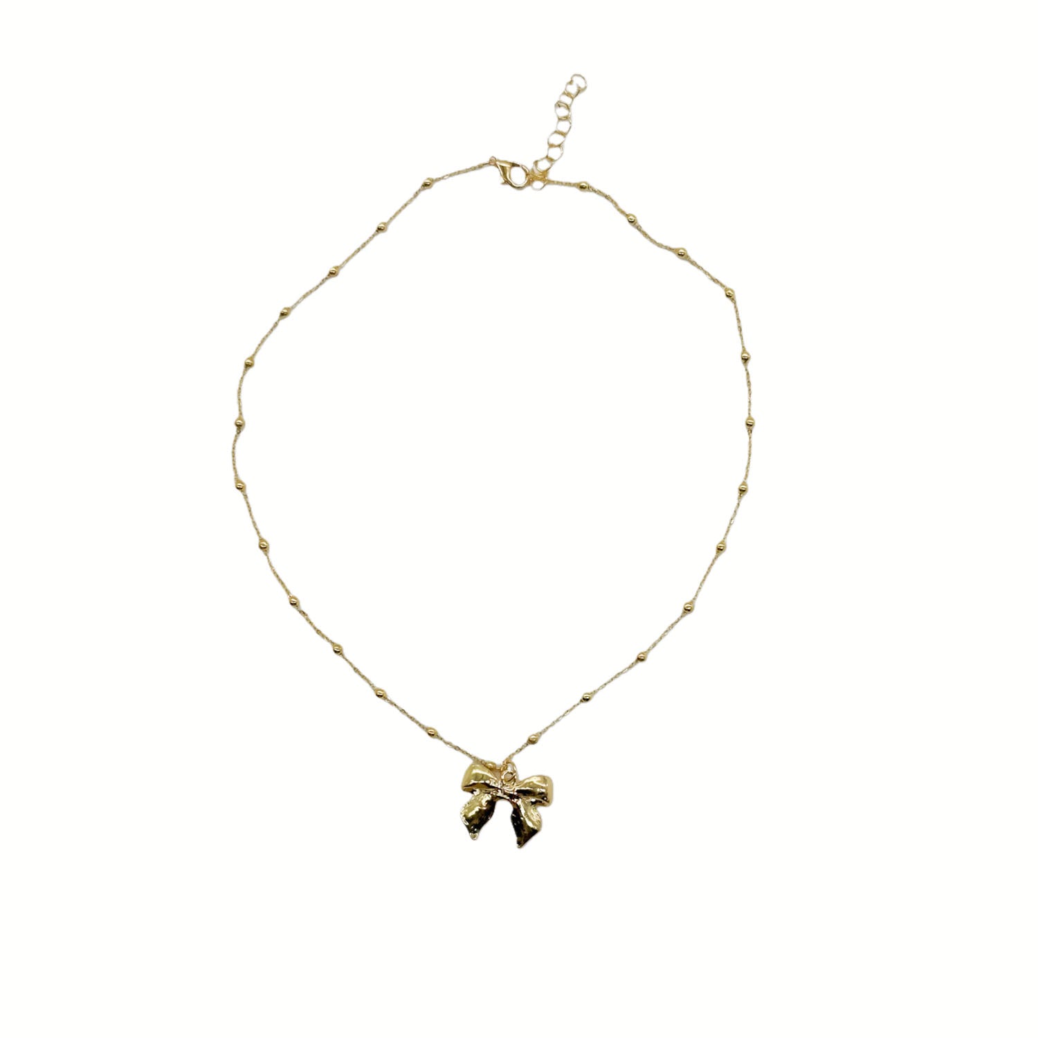 Gold beaded necklace with bow charm pendant at center