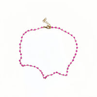 Gold necklace with pink bead strand and clasp at top