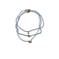 Layered beaded necklace with star charm and crescent moon pendant, light blue