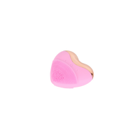 Pink heart-shaped facial cleansing brush with silicone cleaning bristles
