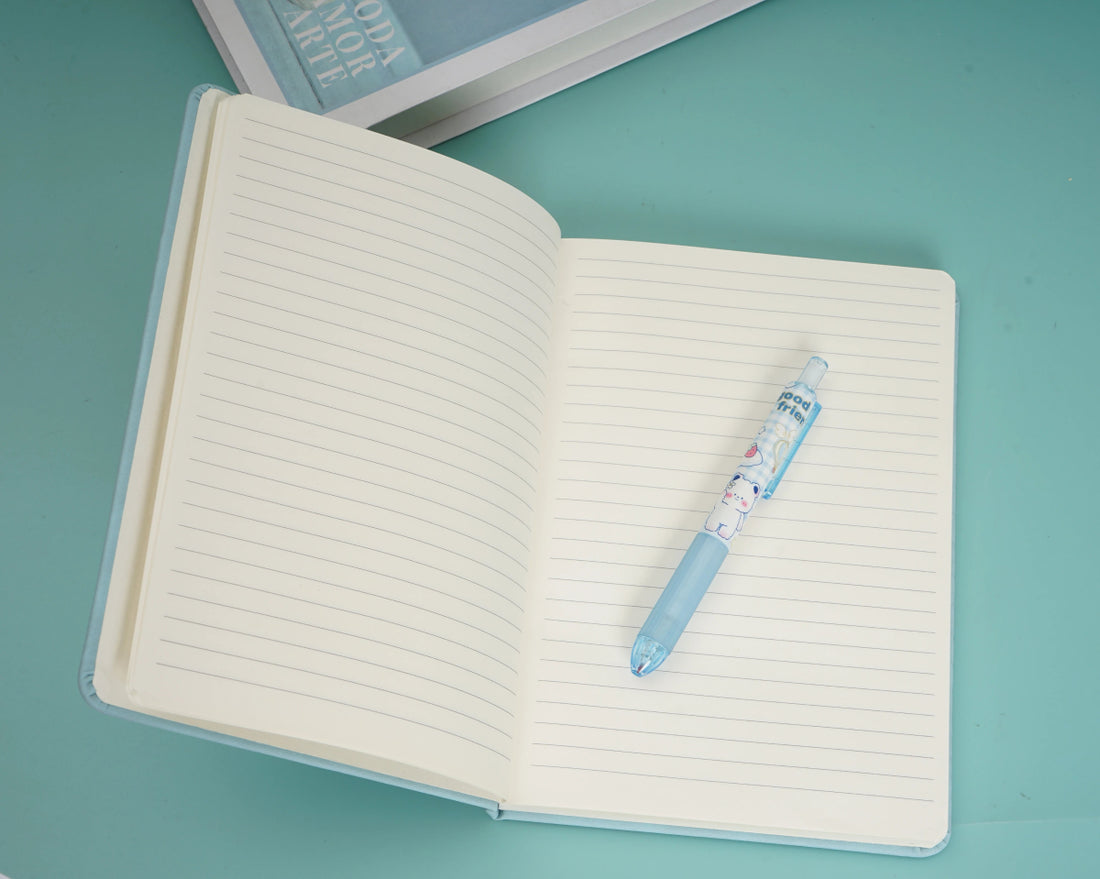 Open A5 dot grid notebook with cream pages and blue pen