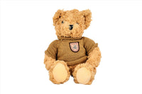 Knitted teddy bear with brown knit sweater and embroidered patch, tan plush fur
