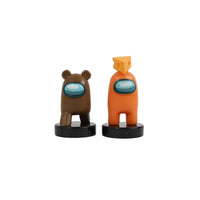 Two crewmate stampers: brown bear-eared and orange with headpiece, on black bases