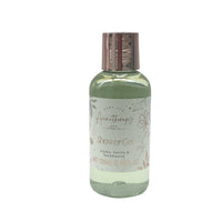 Shower gel bottle with metallic cap and green floral label
