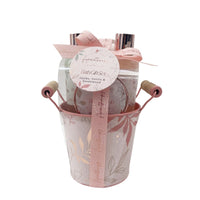 Bath gift set bucket with ribbon bow, showing bottles and a round body scrub lid