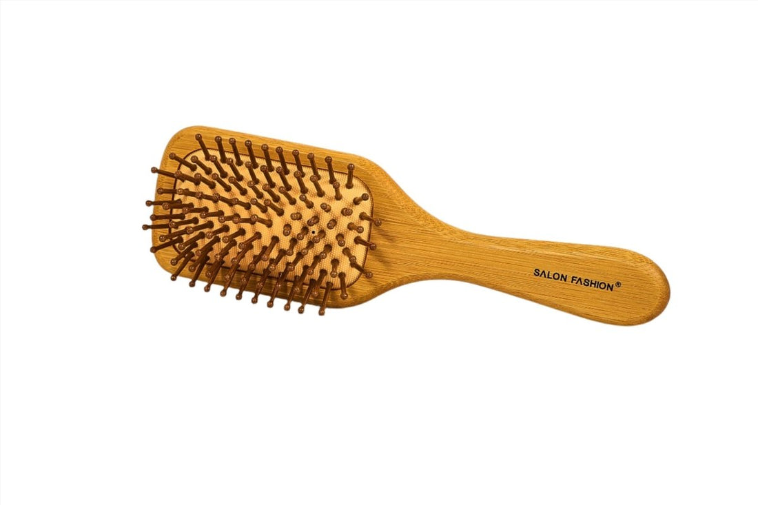 Wooden hair brush with oval bristle pad and curved handle marked SALON FASHION