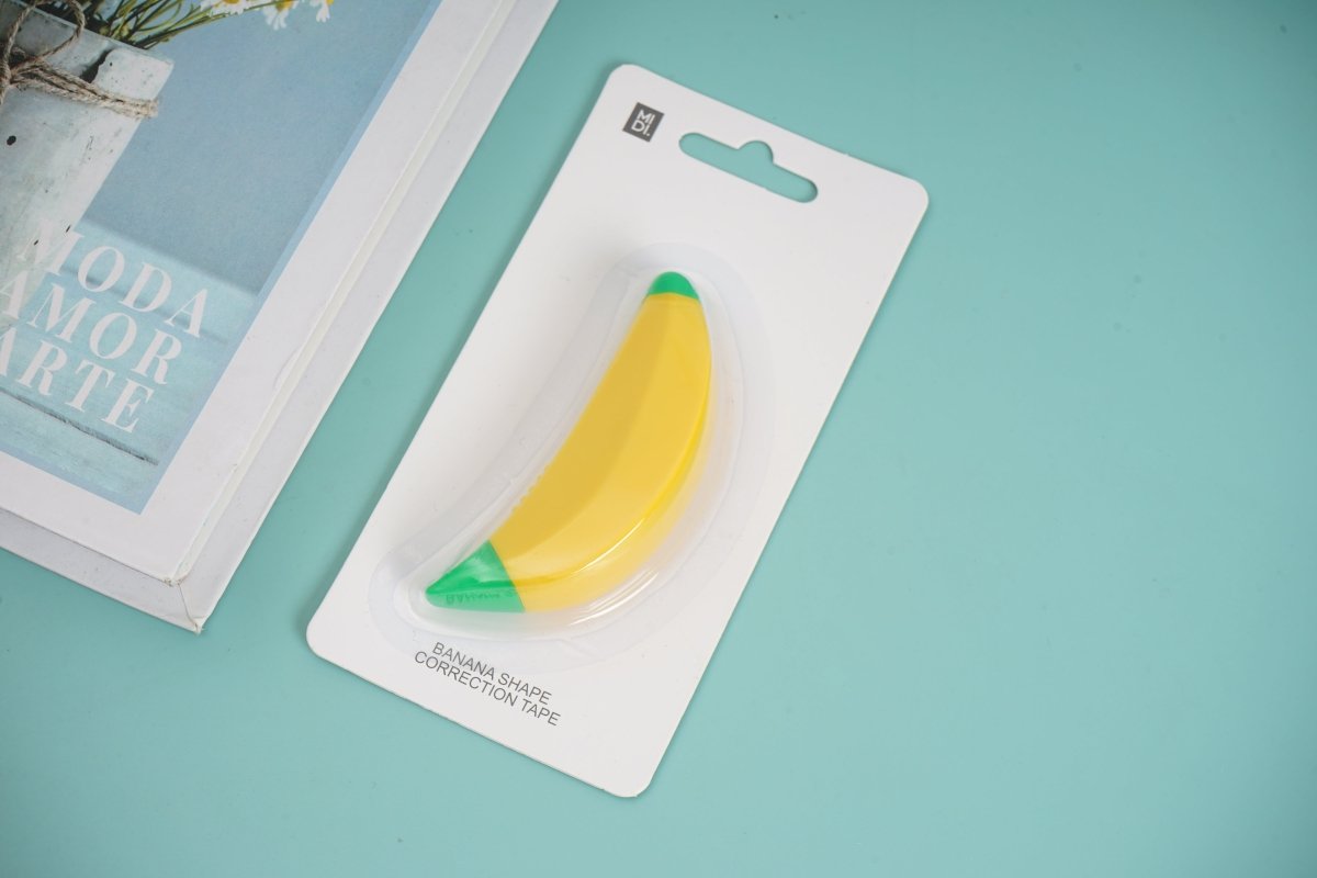 Banana-shaped correction tape in blister card packaging, yellow tape with green end