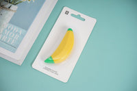 Banana-shaped correction tape in blister card packaging, yellow tape with green end