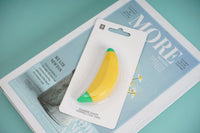 Banana-shaped correction tape blister pack with hanging tab, yellow tape and green end
