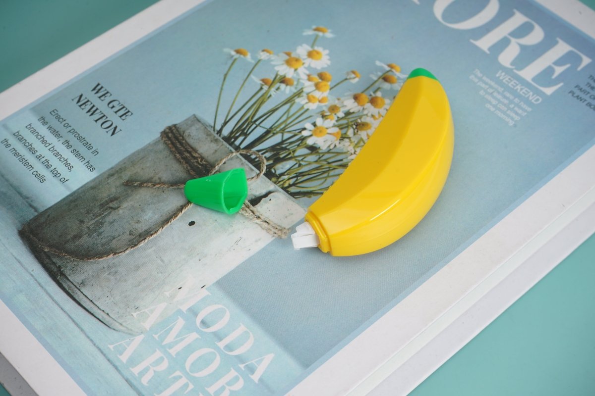Banana-shaped correction tape with yellow body and green cap