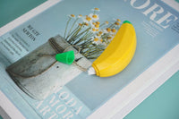 Banana-shaped correction tape with yellow body and green cap