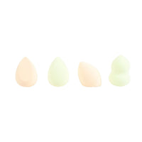 Four makeup blending sponges, teardrop and wedge shapes in pale beige and green